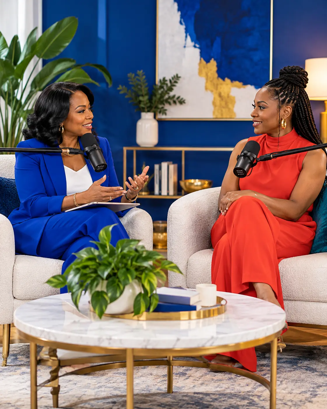 Two women in conversation during a royal blue podcast interview