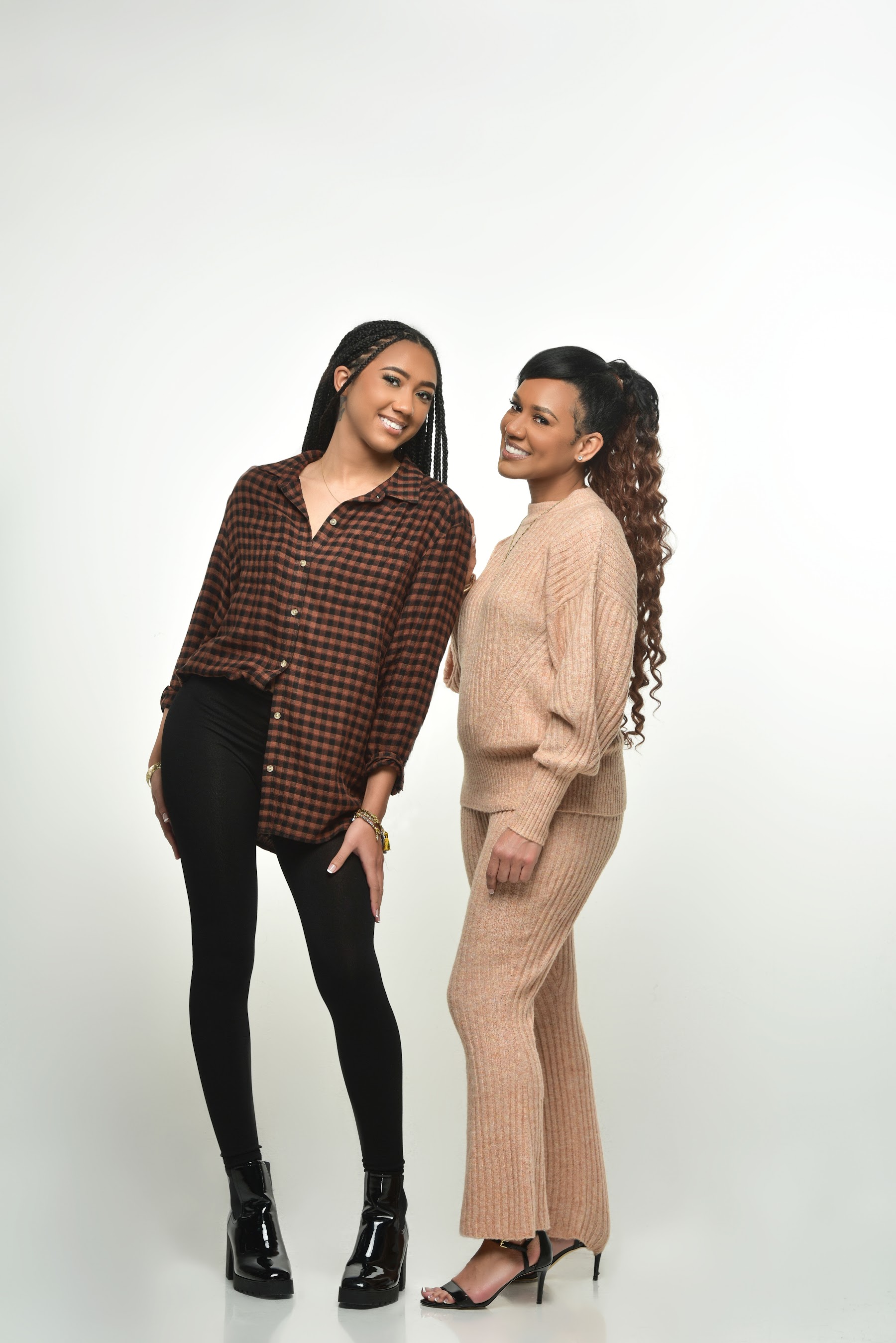 The owners in casual outfits on a white backdrop
